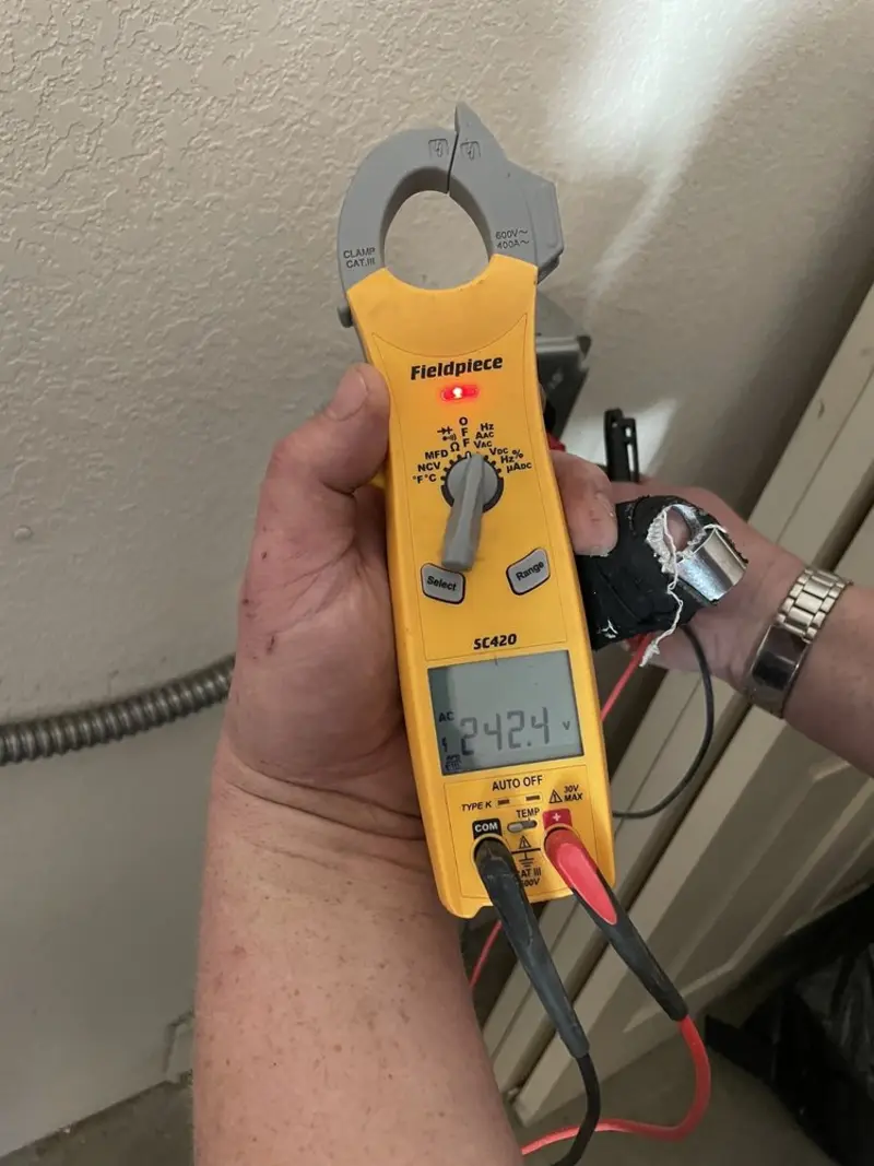 Voltage testing with clamp meter during Recessed Lighting Installation in St. Martinville